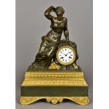 A 19th century gilt bronze and patinated bronze mantel clock Surmounted with a scantily draped