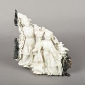 A Chinese carved pale and russet jade group Worked as two goddesses with dragon and temple lion