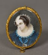 A 19th century miniature portrait on ivory Depicting a young lady in a blue dress with a white