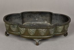 A Chinese cast bronze censor Of quatrefoil form, with lappet band, standing on scroll feet,