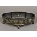 A Chinese cast bronze censor Of quatrefoil form, with lappet band, standing on scroll feet,