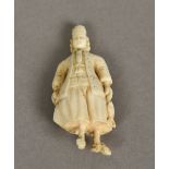 A carved ivory needle case Worked as a Dutchman. 6 cm high.