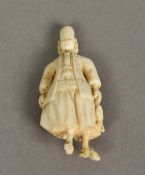 A carved ivory needle case Worked as a Dutchman. 6 cm high.