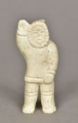 An Inuit carved marine ivory figure of a fisherman 9 cm high.