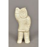 An Inuit carved marine ivory figure of a fisherman 9 cm high.