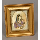 A 19th century Indian miniature portrait on ivory Depicting a bejewelled young lady,
