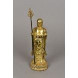 A Chinese gilt bronze figure of a deity Modelled standing holding a pearl and a staff with pierced