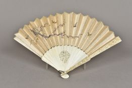 A late 19th century Cantonese carved ivory and silk fan The guards typically carved with figures