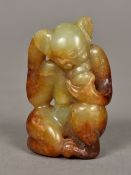 A Chinese carved celadon and russet jade monkey 5.5 cm high.