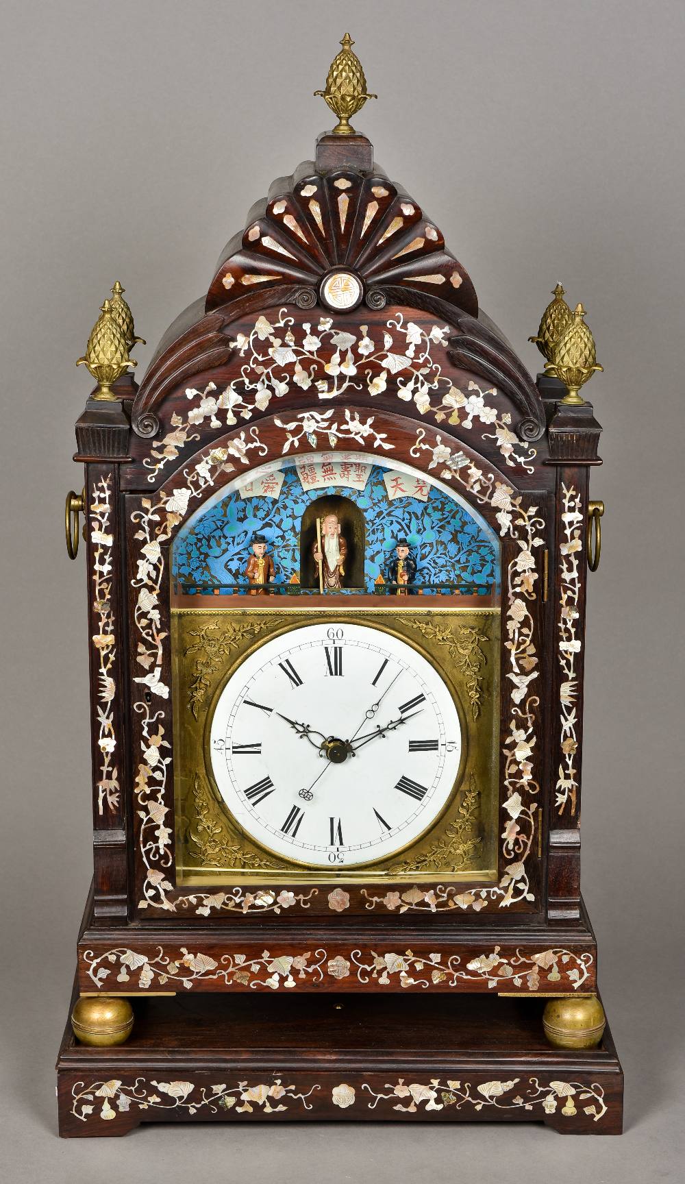 A Chinese mother-of-pearl inlaid hardwood cased automaton table clock The 8 1/2 inch white painted