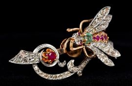 A 14 ct gold diamond, ruby and emerald en tremblant bug brooch, stamped 585 6 cm wide.