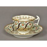 A Swansea porcelain tea cup and saucer Brightly decorated with scrolls and floral sprays,