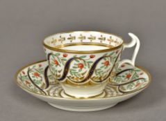 A Swansea porcelain tea cup and saucer Brightly decorated with scrolls and floral sprays,
