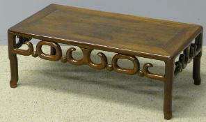 A 19th century Chinese hardwood coffee table The panelled rectangular top above the carved frieze,