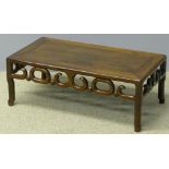 A 19th century Chinese hardwood coffee table The panelled rectangular top above the carved frieze,