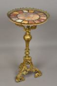 A specimen marble topped centre table The circular top above the gilt metal base. 46 cm diameter.