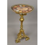 A specimen marble topped centre table The circular top above the gilt metal base. 46 cm diameter.