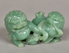 A Chinese celadon coloured jade carving Modelled as two dogs-of-fo at play. 9.5 cm wide.