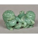 A Chinese celadon coloured jade carving Modelled as two dogs-of-fo at play. 9.5 cm wide.