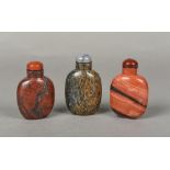 Three Chinese carved hardstone snuff bottles and stoppers The largest 8 cm high.