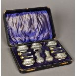 A cased seven piece Edwardian silver condiments set, hallmarked Birmingham 1904,