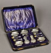 A cased seven piece Edwardian silver condiments set, hallmarked Birmingham 1904,