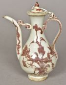 A Chinese porcelain ewer Decorated with floral sprays in iron red. 18.5 cm high.