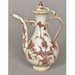A Chinese porcelain ewer Decorated with floral sprays in iron red. 18.5 cm high.