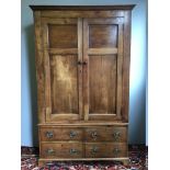 A 19th century French fruitwood armoire The moulded cornice above the twin panelled doors enclosing