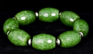 A jade bracelet Each bead facet cut. Approximately 20 cm long.