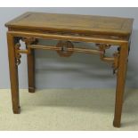 A 19th century Chinese elm table The panelled rectangular top above the scroll carved pierced
