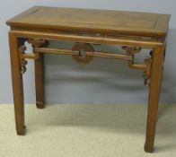 A 19th century Chinese elm table The panelled rectangular top above the scroll carved pierced