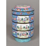 A Chinese Canton enamel stacking box and cover Comprising three sections decorated with figural