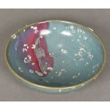 A Chinese Jun ware bowl Typically glazed with remnants of barnacle encrustation. 18 cm diameter.