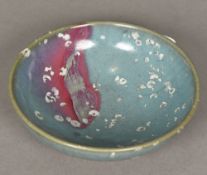 A Chinese Jun ware bowl Typically glazed with remnants of barnacle encrustation. 18 cm diameter.