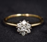 A 14K gold and diamond ring Of flowerhead form.