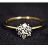 A 14K gold and diamond ring Of flowerhead form.