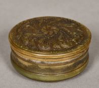 A 19th century horn snuff box Of circular form, with pressed floral decorations. 7 cm diameter.