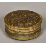 A 19th century horn snuff box Of circular form, with pressed floral decorations. 7 cm diameter.