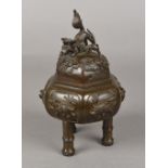 A Chinese cast bronze censor and cover The domed cover with temple lion finial and worked with