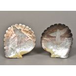 A pair of carved oyster shells Each respectively carved to the interior with a fisherman and fisher