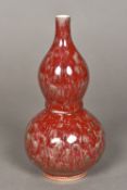 A Chinese porcelain double gourd vase With allover souffle glaze. 20.5 cm high.