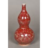 A Chinese porcelain double gourd vase With allover souffle glaze. 20.5 cm high.