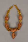 A Chinese carved nut and faceted bead necklace Set with five carved nut beads,