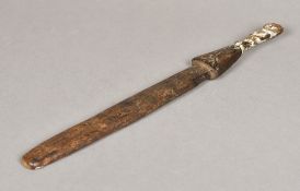 An African tribal carved wooden ritual or medicine stick The handle formed as male figure with