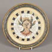 A framed circular mosaic panel The specimen stone roundel depicting a bust. 24 cm diameter.