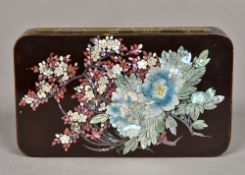 A late 19th century Japanese lacquered tin Of hinged rounded rectangular form,