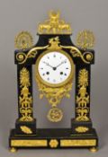 A French Empire gilt bronze marble black marble mantel clock Of portico form,