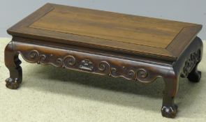 An 18th/19th century Chinese hardwood coffee table The panelled rectangular top above the scroll