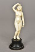 A small early 20th century ivory figurine Carved as a nude woman,